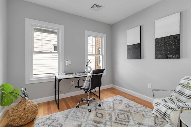 office space with light hardwood / wood-style floors