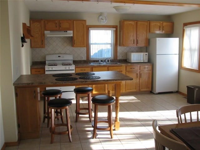 436 Brown St, Attleboro, MA 02703 - kitchen featuring white appliances, under cabinet range hood, a sink, and healthy amount of natural light