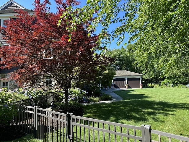 view of yard with a garage and an outdoor structure