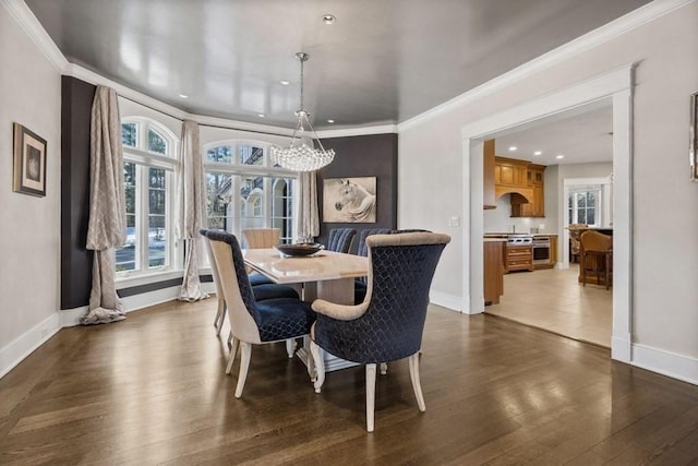 dining area with dark hardwood / wood-style floors and crown molding