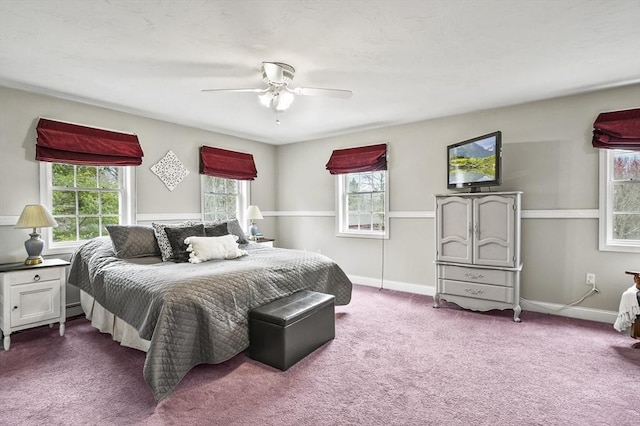 carpeted bedroom with baseboards and a ceiling fan
