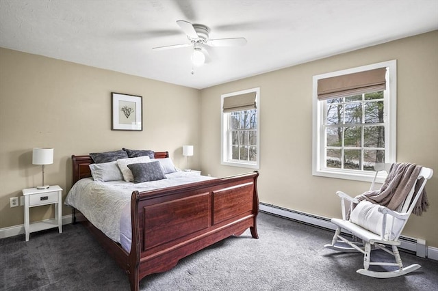 bedroom with carpet, multiple windows, and a baseboard heating unit