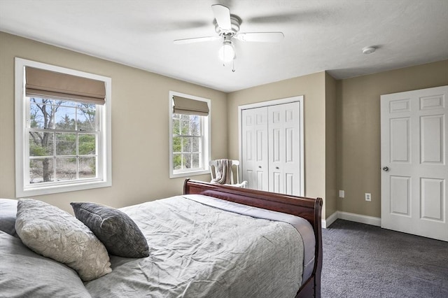 bedroom featuring ceiling fan, a closet, baseboards, and dark carpet