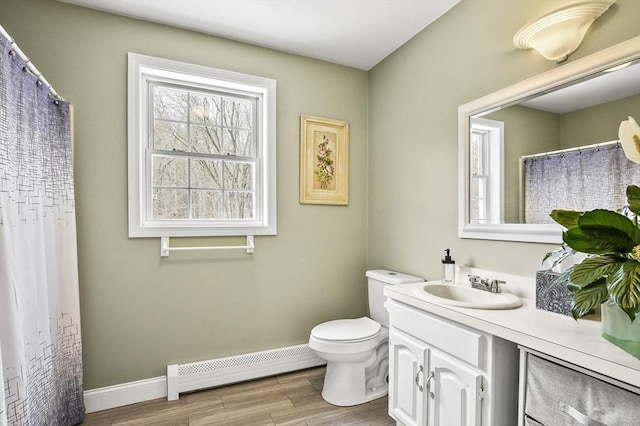 full bathroom with toilet, wood finished floors, vanity, a baseboard radiator, and baseboards