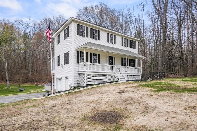 view of front of home featuring driveway and a porch