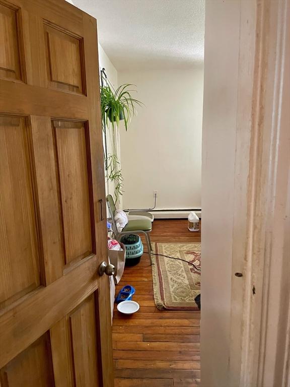 corridor featuring wood finished floors