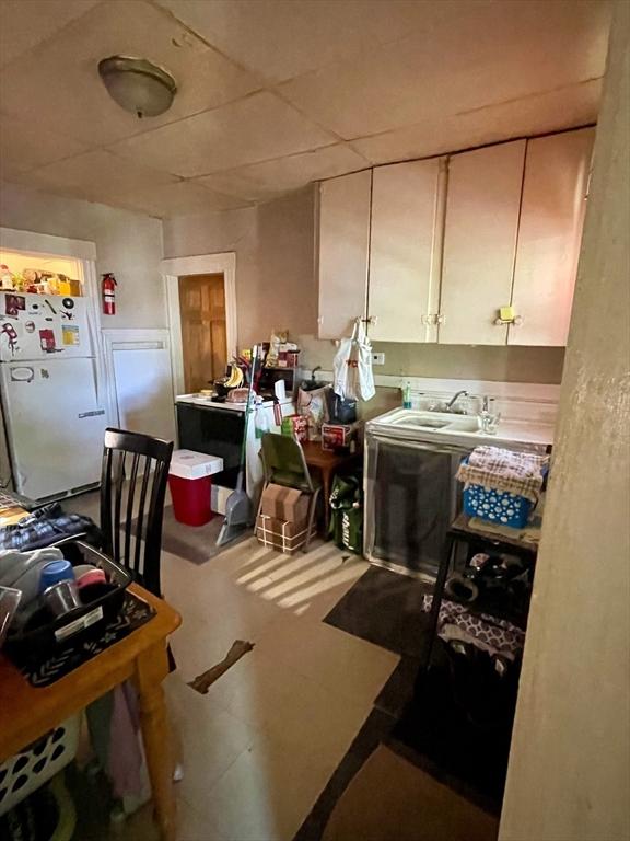 kitchen with a sink and freestanding refrigerator