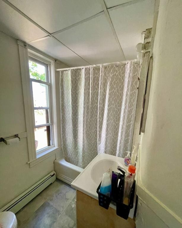 full bath with vanity, plenty of natural light, shower / tub combo, and baseboard heating