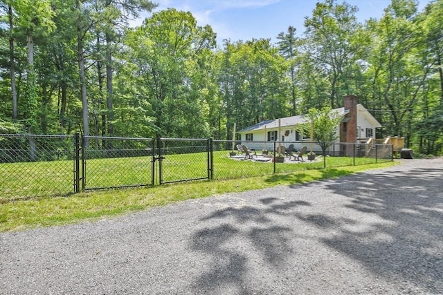 180 Slab Bridge Rd, Freetown, MA 02702 - view of asphalt driveway with a gate and a forest view
