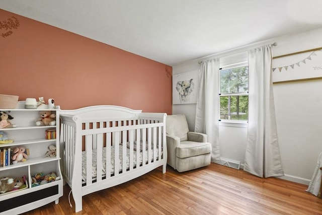 180 Slab Bridge Rd, Freetown, MA 02702 - bedroom with wood finished floors and a nursery area