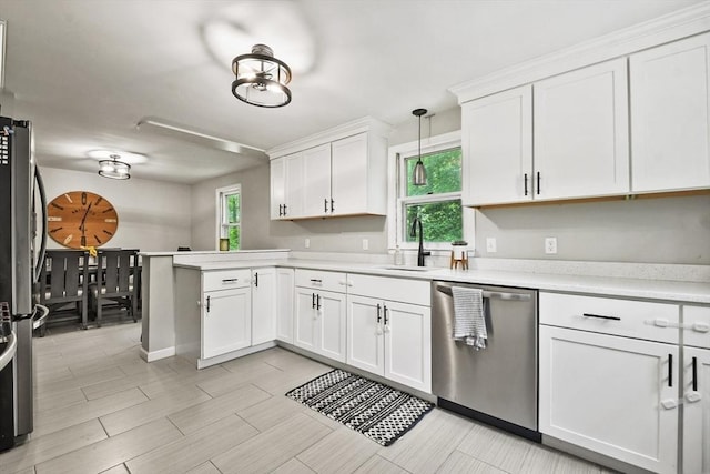 180 Slab Bridge Rd, Freetown, MA 02702 - kitchen featuring stainless steel appliances, light countertops, a peninsula, white cabinetry, and decorative light fixtures