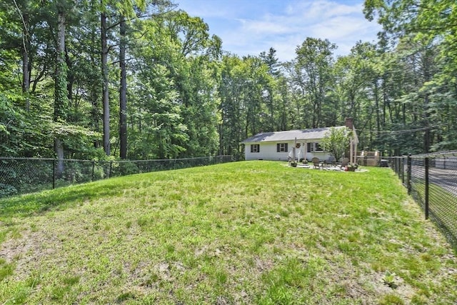 180 Slab Bridge Rd, Freetown, MA 02702 - fenced backyard with a wooded view and a patio area