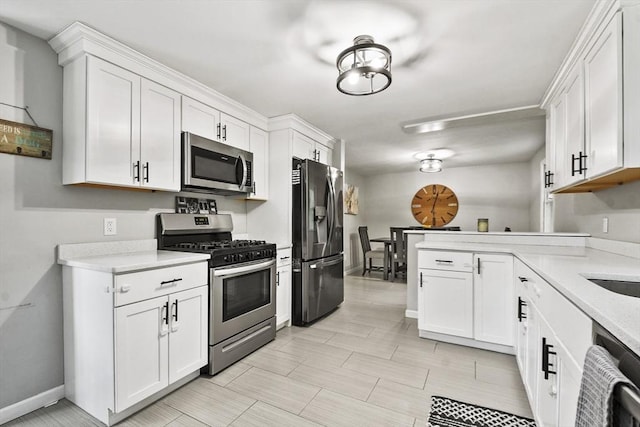180 Slab Bridge Rd, Freetown, MA 02702 - kitchen with stainless steel appliances, white cabinets, and a peninsula