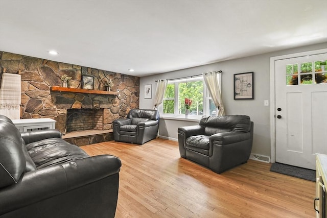 180 Slab Bridge Rd, Freetown, MA 02702 - living room featuring light wood-type flooring, a stone fireplace, and recessed lighting