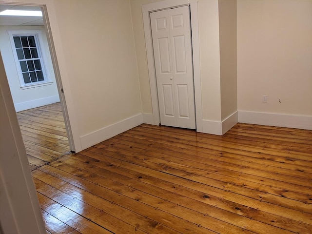 unfurnished bedroom with hardwood / wood-style flooring and a closet