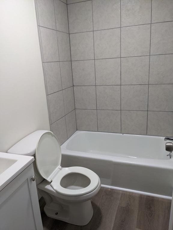 bathroom with toilet, vanity, and hardwood / wood-style floors