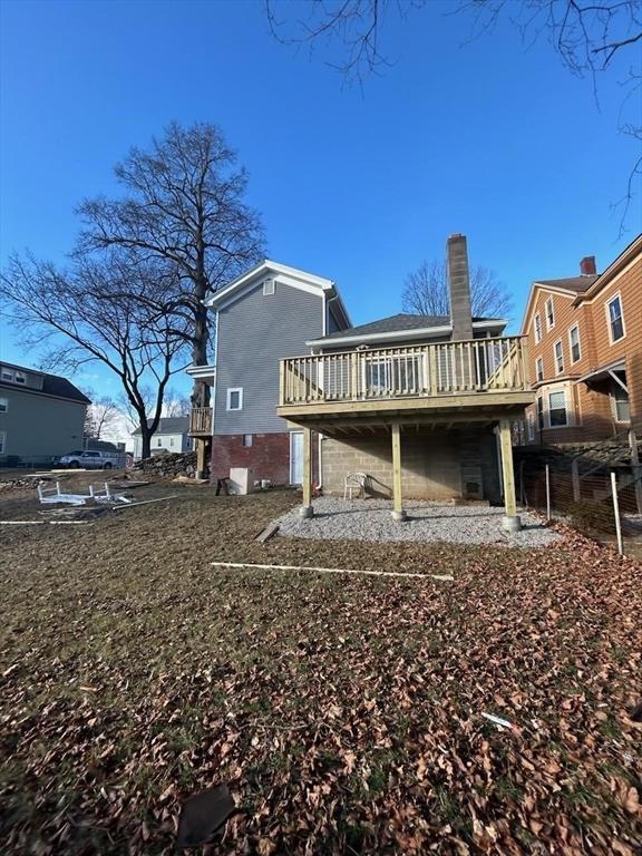 back of property featuring a wooden deck