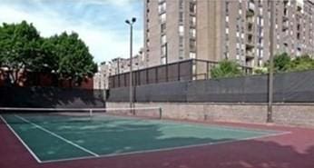 view of tennis court featuring fence