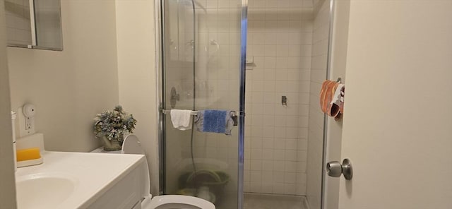 full bathroom with a stall shower, toilet, and vanity