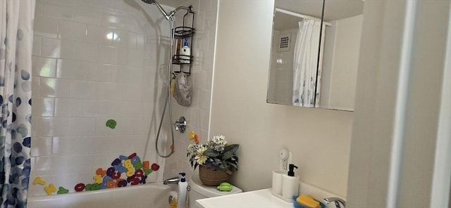 bathroom featuring shower / bath combination with curtain and toilet