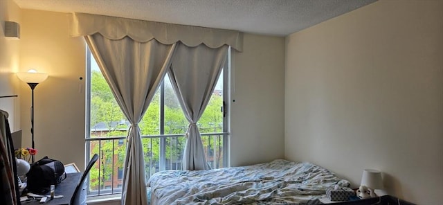 bedroom with multiple windows and a textured ceiling