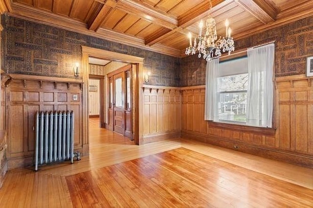 mudroom with crown molding, a notable chandelier, radiator heating unit, wood finished floors, and wood ceiling