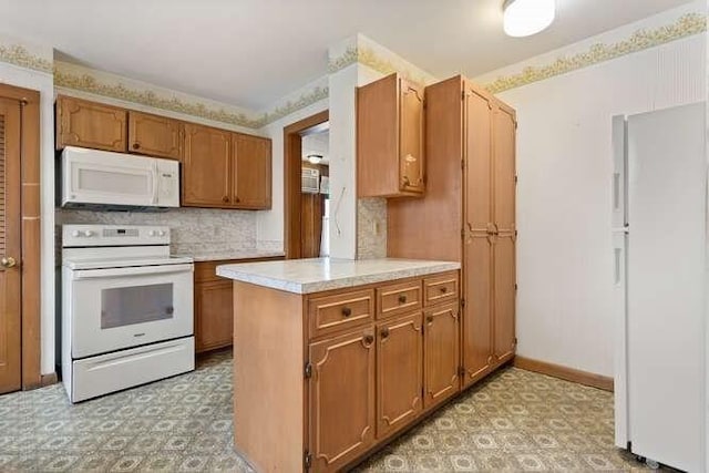 kitchen with white appliances, light countertops, brown cabinets, and light floors