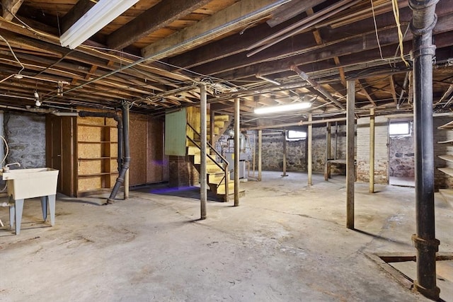 basement with a sink and stairs