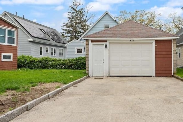 detached garage featuring concrete driveway