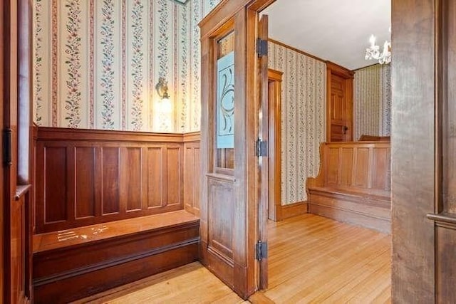 view of sauna / steam room with wainscoting, wallpapered walls, and wood finished floors