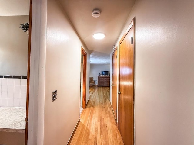 corridor featuring light wood-style floors