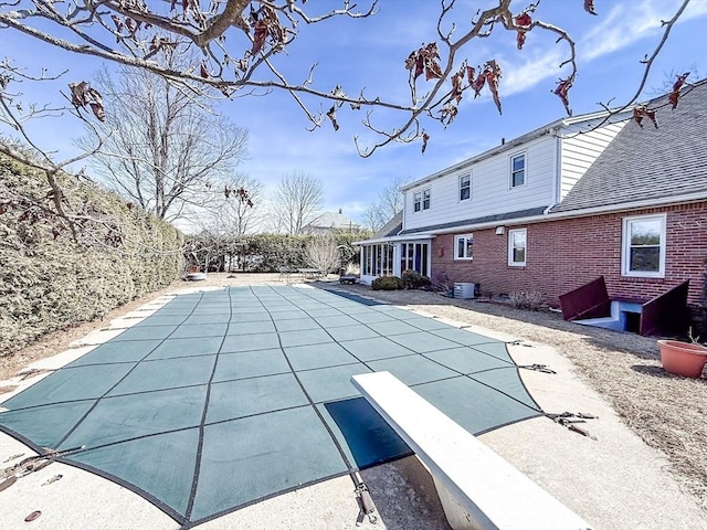 view of pool featuring a patio and a diving board