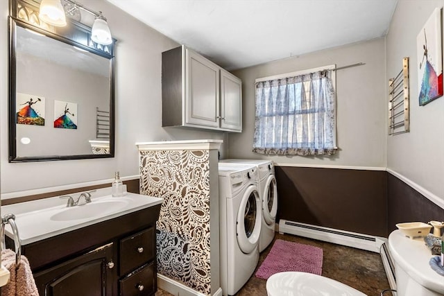 washroom with independent washer and dryer, baseboard heating, and sink