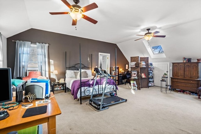 carpeted bedroom with ceiling fan and vaulted ceiling with skylight