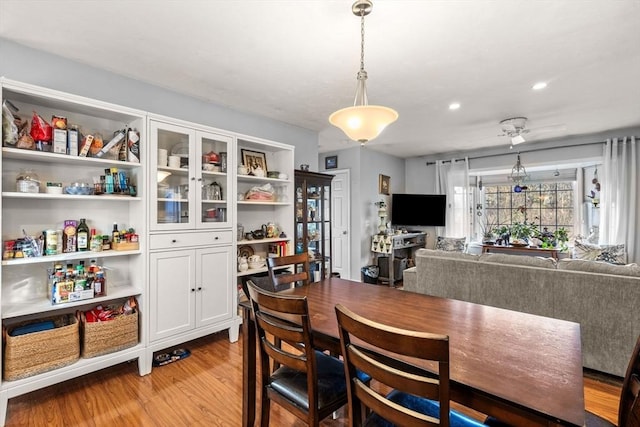 dining space featuring ceiling fan and light hardwood / wood-style flooring