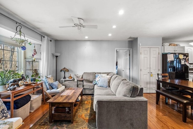 living room featuring hardwood / wood-style flooring and ceiling fan