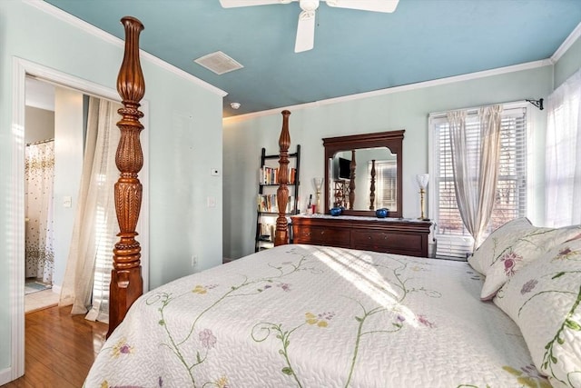 bedroom with hardwood / wood-style flooring, ceiling fan, and ornamental molding