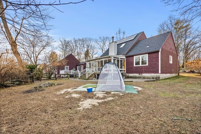 back of property featuring a sunroom