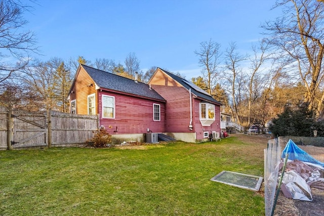 view of side of property with a yard and central AC unit