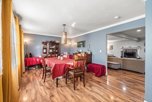 dining space featuring wood-type flooring and ornamental molding