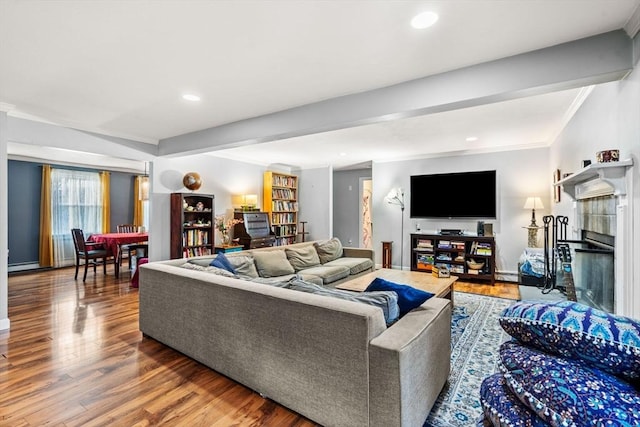 living room featuring beamed ceiling, hardwood / wood-style flooring, and crown molding