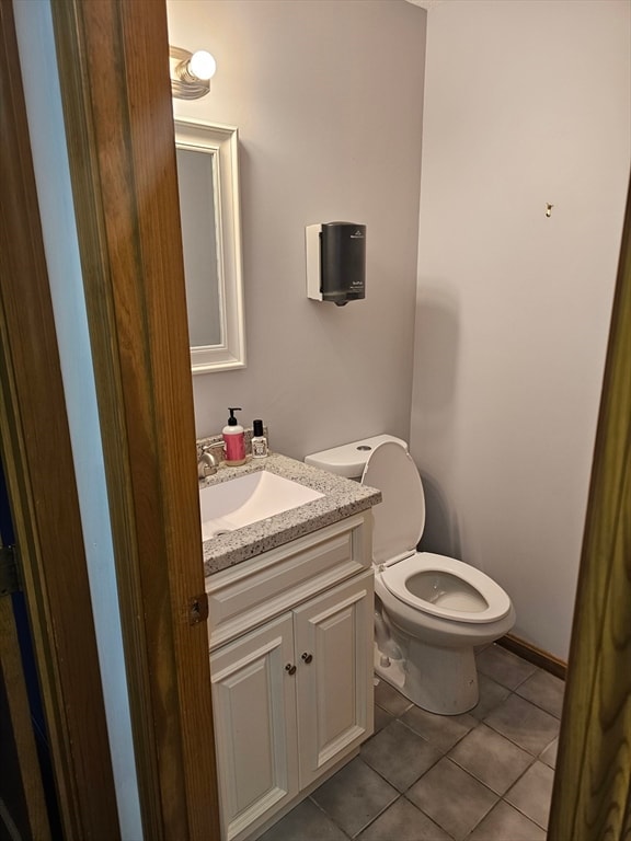 bathroom with tile patterned floors, vanity, and toilet