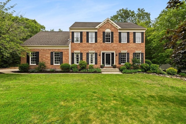 3 Norumbega Cir, Franklin, MA 02038 - colonial inspired home featuring brick siding, a front yard, and a shingled roof