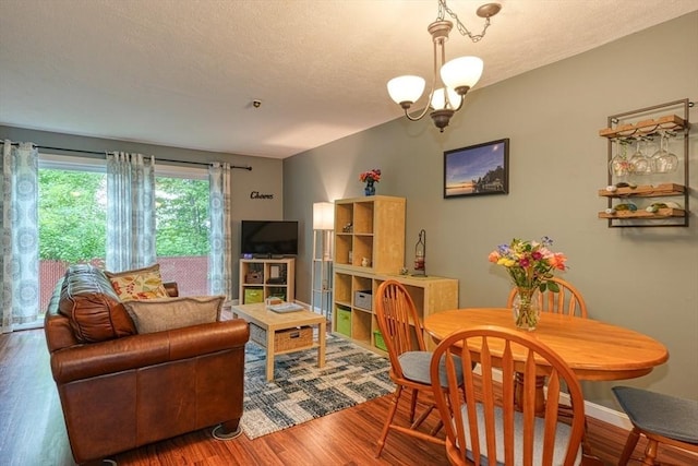 280 Elm St Unit 26, Marlborough, MA 01752 - living room with a chandelier, wood finished floors, a textured ceiling, and baseboards