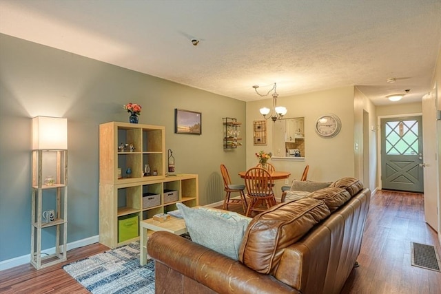 280 Elm St Unit 26, Marlborough, MA 01752 - living room featuring wood finished floors, baseboards, and a chandelier