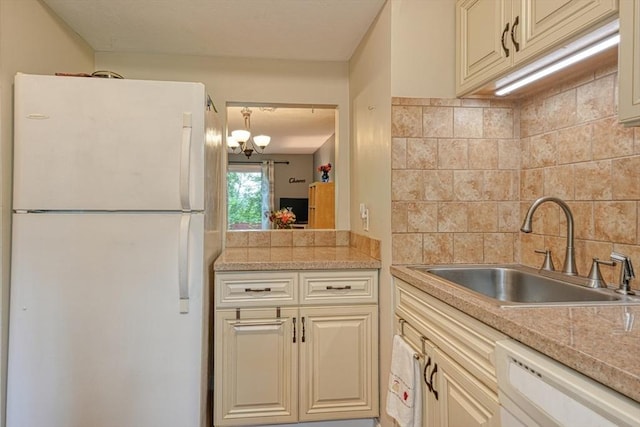 280 Elm St Unit 26, Marlborough, MA 01752 - kitchen featuring white appliances, a sink, light countertops, decorative backsplash, and a chandelier