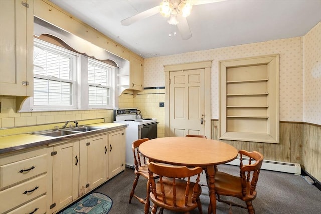 160 Shrewsbury St, Holden, MA 01520 - kitchen with wallpapered walls, white electric stove, a wainscoted wall, a sink, and baseboard heating