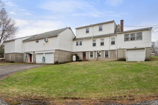 160 Shrewsbury St, Holden, MA 01520 - rear view of house with a chimney, driveway, a lawn, and a garage