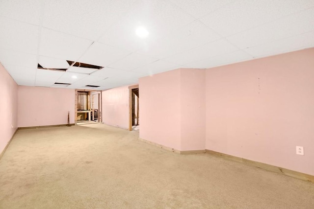 spare room featuring carpet floors and a drop ceiling