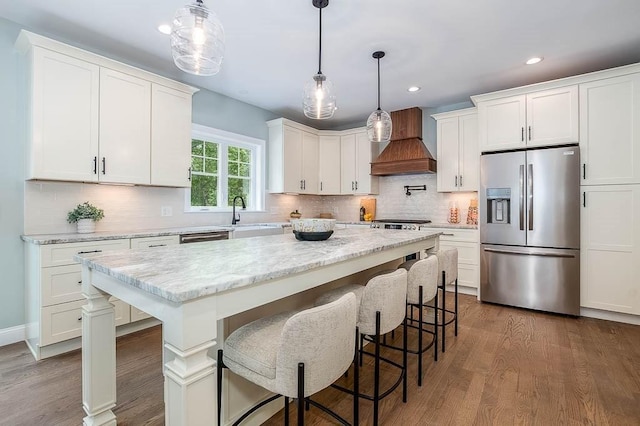 131 Colts Way, Attleboro, MA 02703 - kitchen featuring appliances with stainless steel finishes, custom exhaust hood, a sink, white cabinets, and recessed lighting
